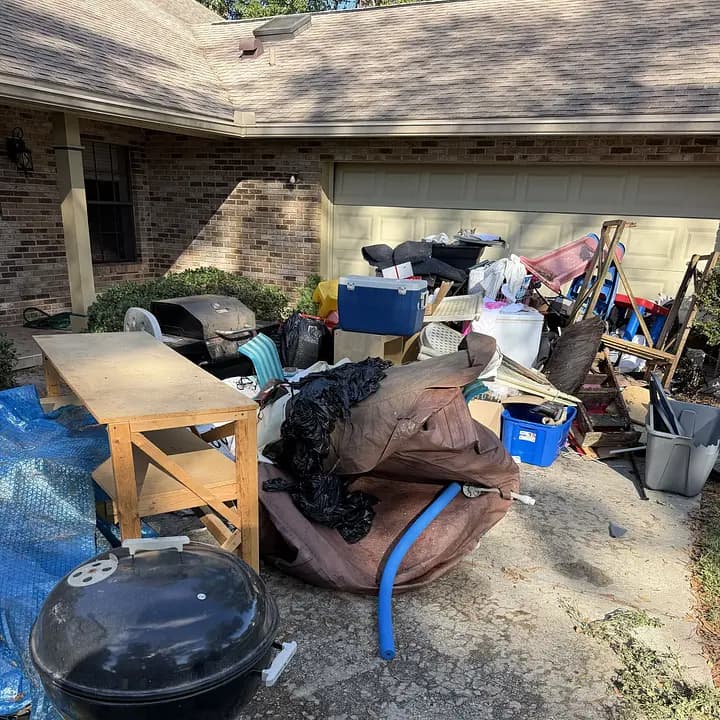 Garage cleanout pile staged on a driveway before Big Rob's Hauling loads it in Polk County, FL