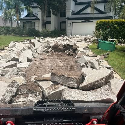 Broken concrete from a driveway removal loaded on a Big Rob's Hauling trailer in Polk County, FL
