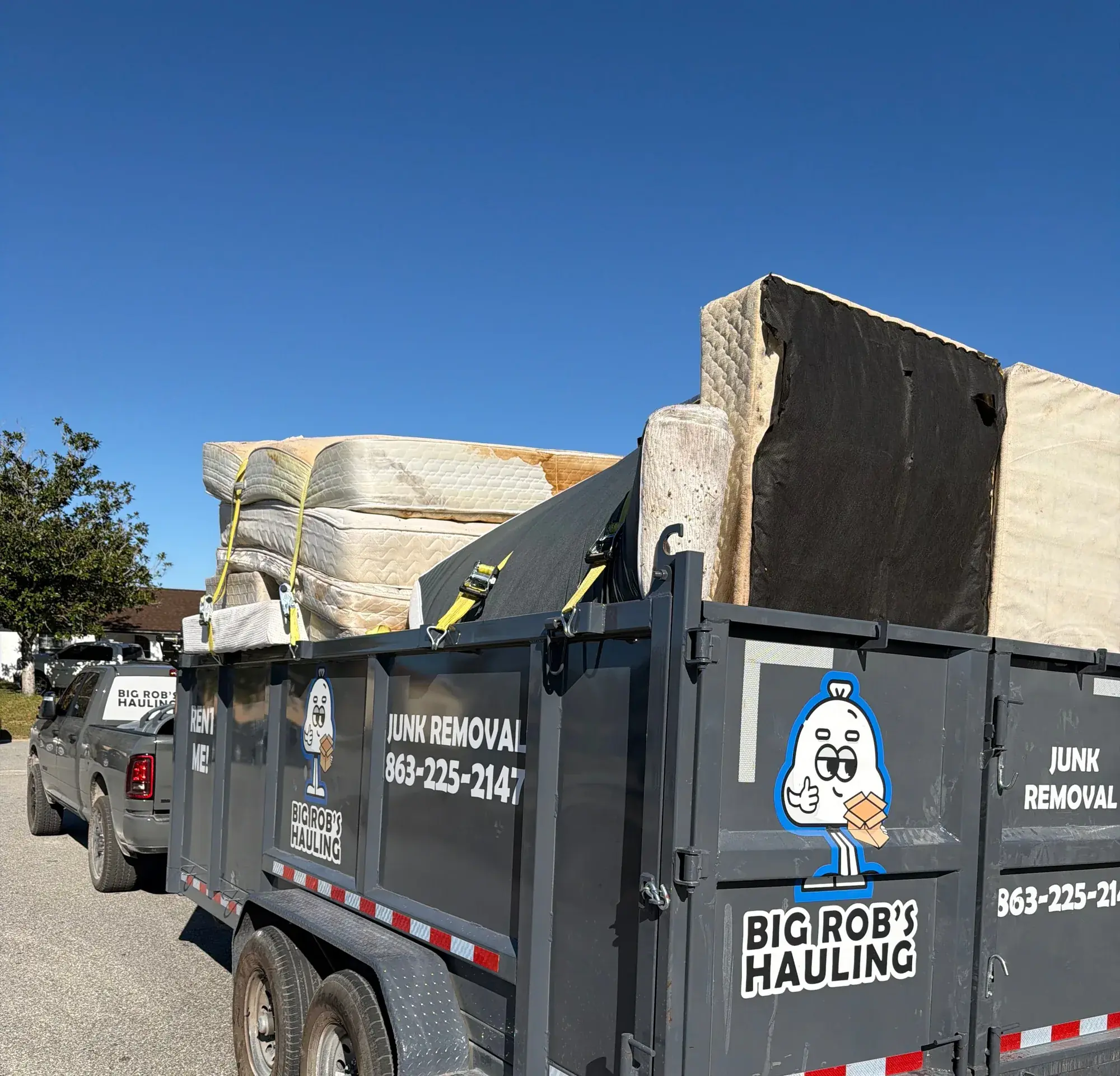 Big Rob's Hauling dump trailer loaded with mattresses and box springs on a Central Florida street