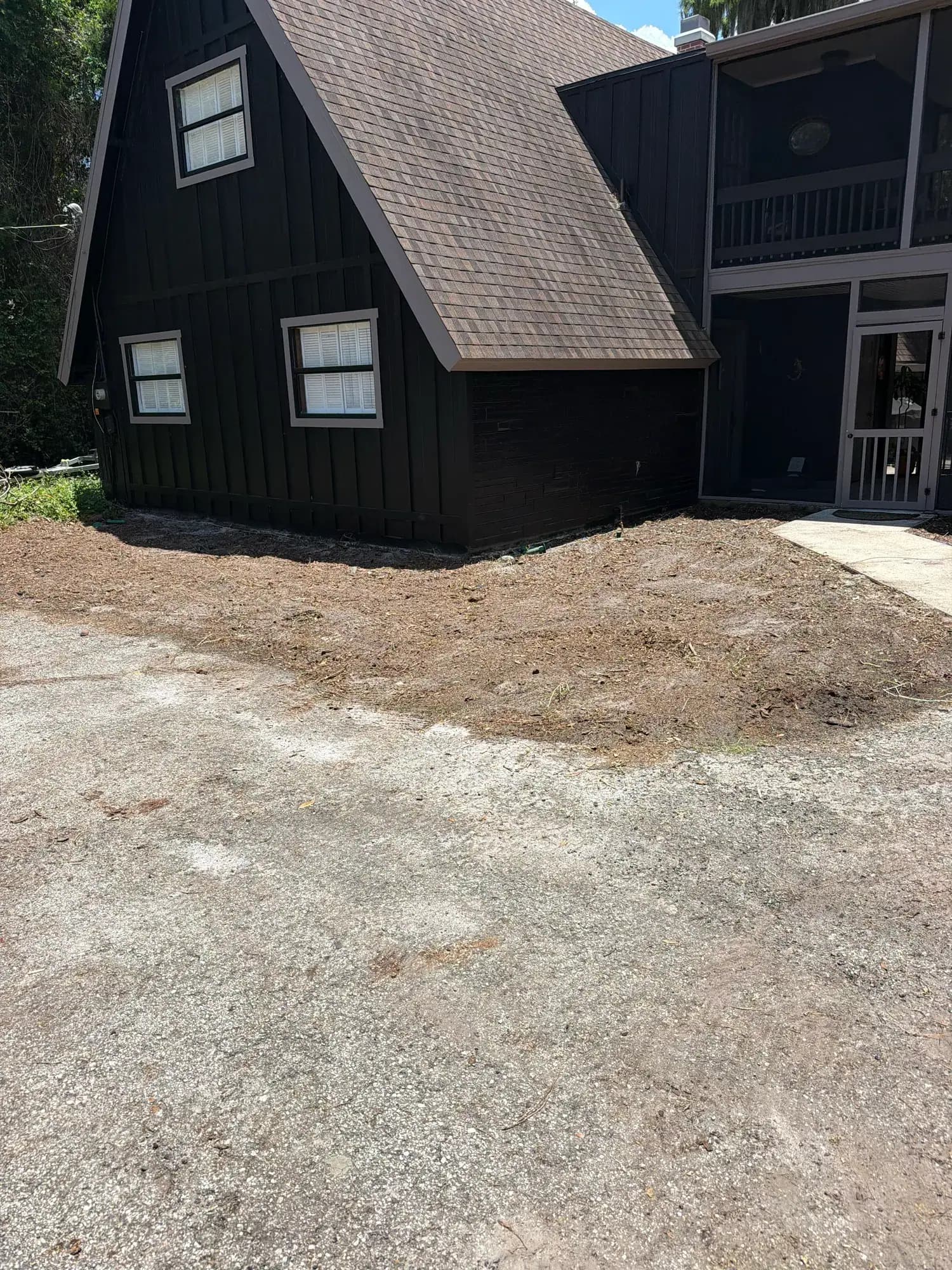 Ground graded smooth around a Central Florida house after Big Rob's Hauling pulled the old landscaping
