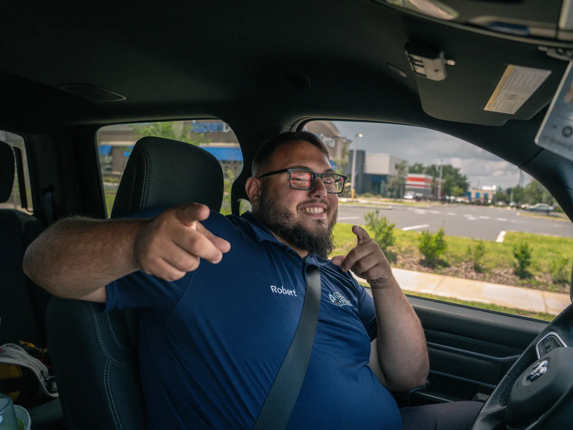 Rob of Big Rob's Hauling in the cab of his Ram truck in Davenport, FL