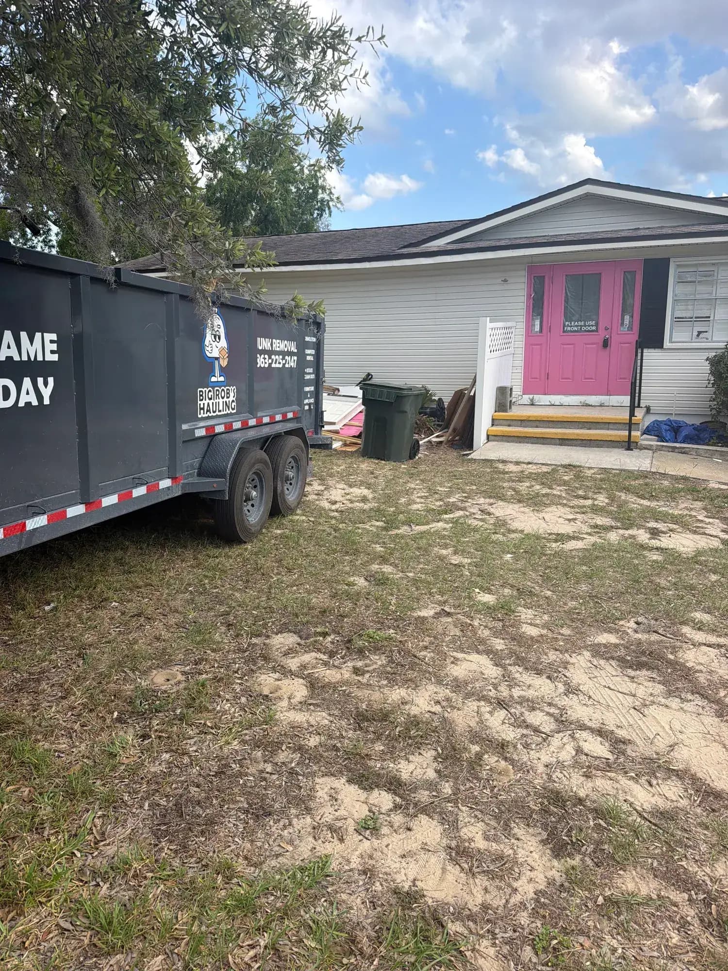 Big Rob's Hauling Same Day dump trailer parked in a Central Florida driveway for a cleanout