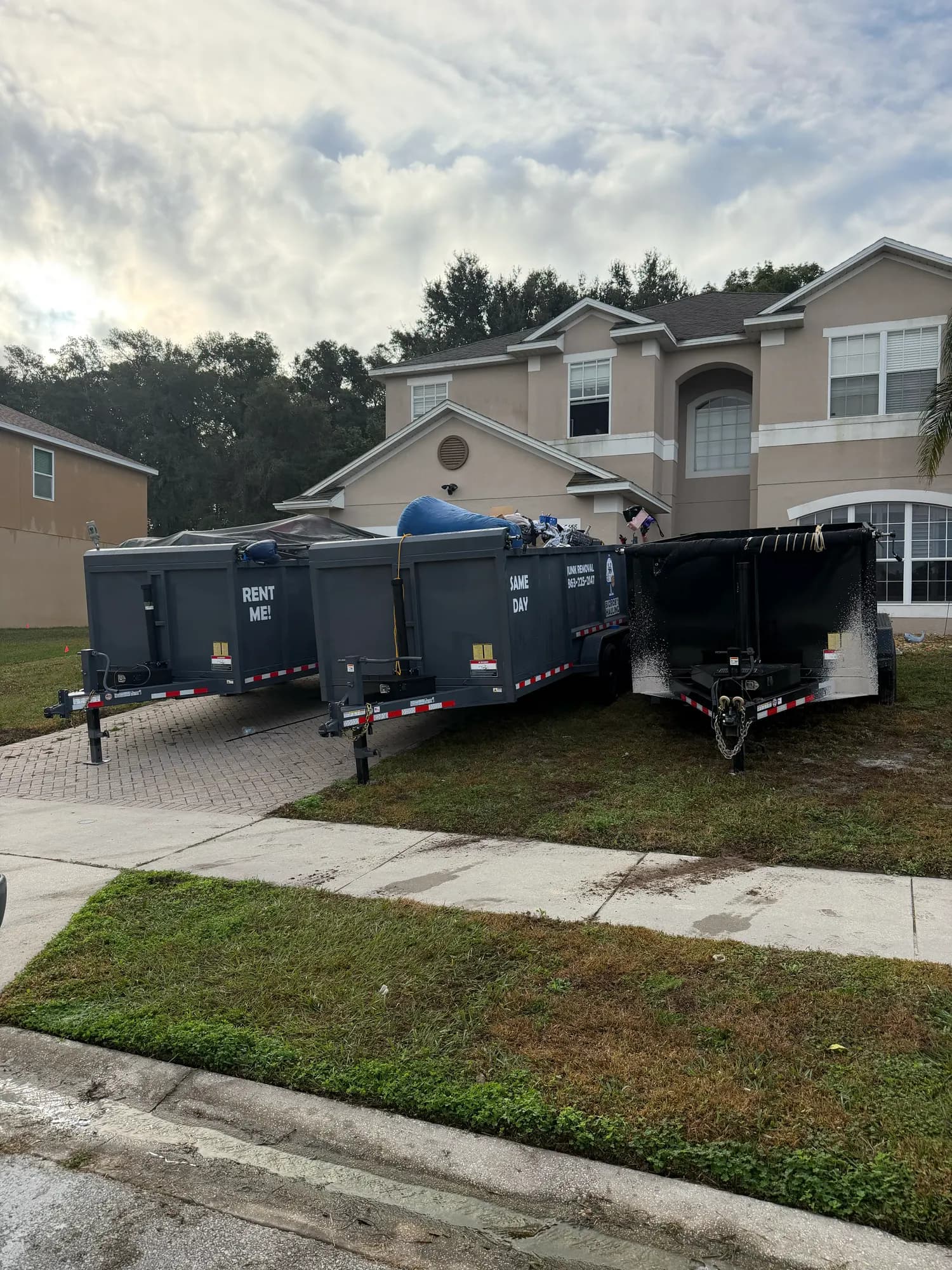 Two Big Rob's Hauling dump trailers parked at a two-story Lake County, FL home for a whole-house cleanout